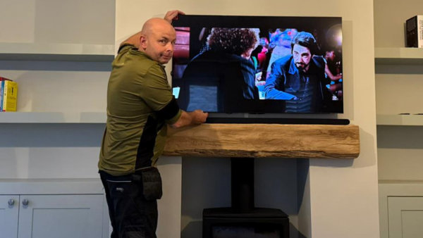 TV mounted on the wall above the fireplace